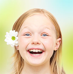 patient smiling after visiting a pediatric dentist in Garland, TX