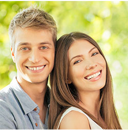 male and female patients smiling after visiting an emergency dentistry in Garland, TX