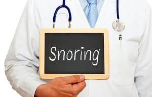 Doctor Holding Sign that Says 'Snoring'